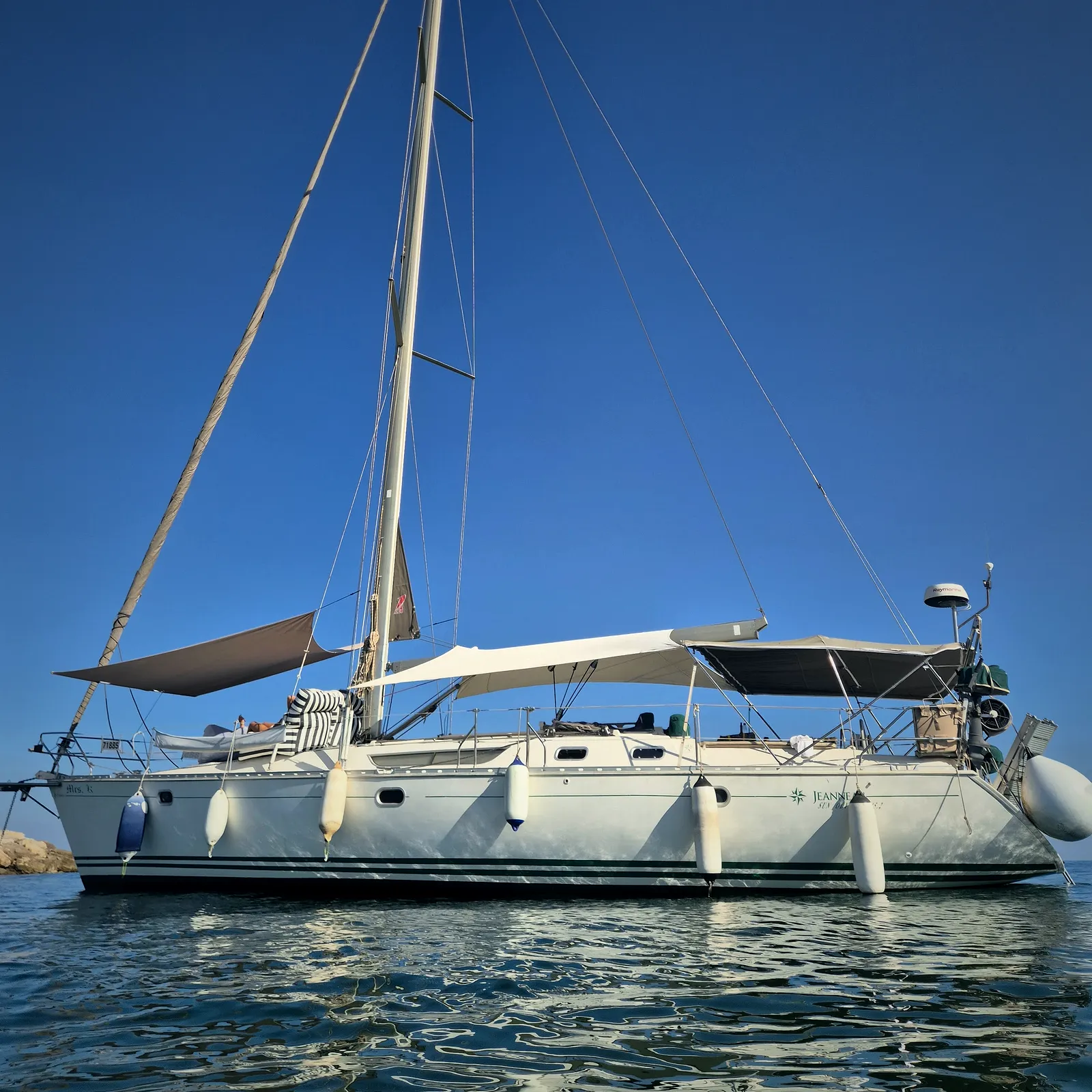 A sailing yacht on a mooring with SunSkipper rigged at the bow