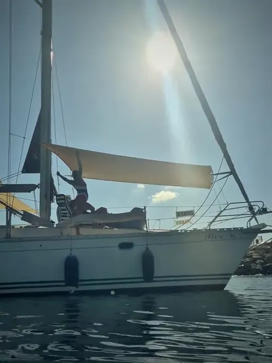 Someone relaxing in the shade of SunSkipper on the foredeck