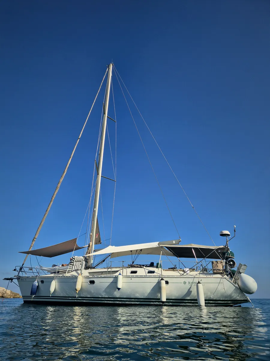 A sailing yacht at anchor with SunSkipper over the foredeck