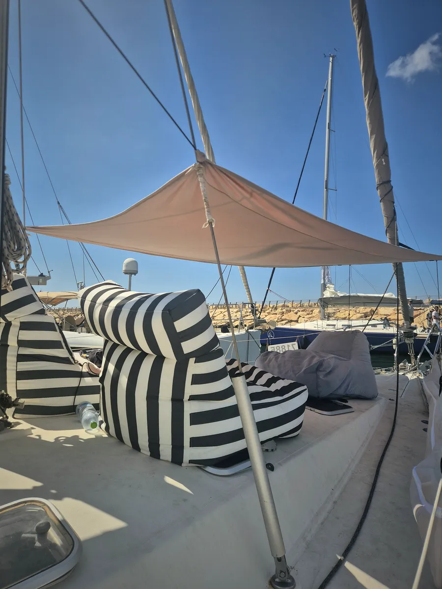 Lounge chairs on the foredeck under a SunSkipper canopy in the marina